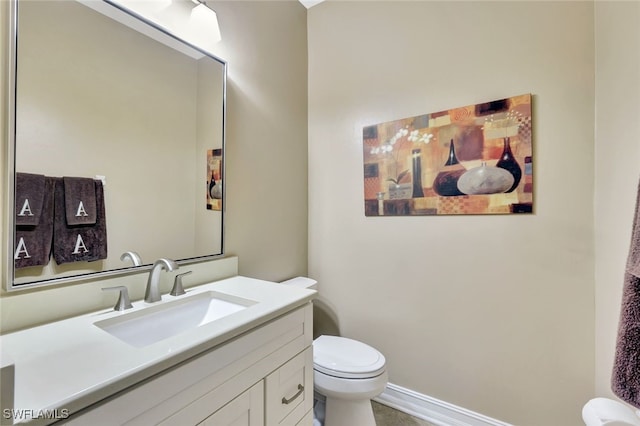 bathroom featuring toilet and vanity