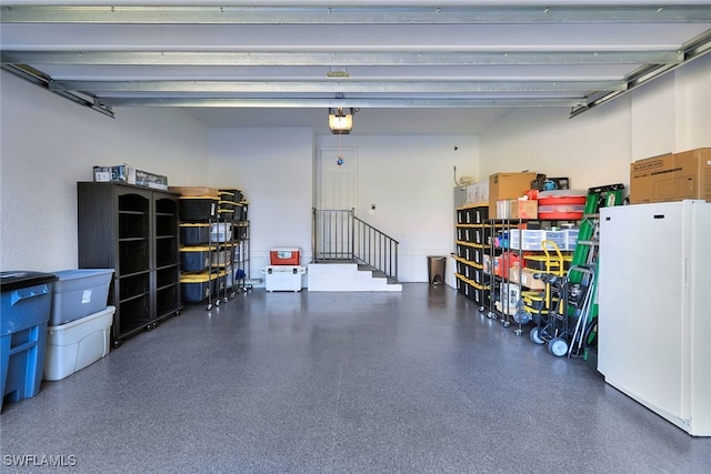 garage featuring a garage door opener and white refrigerator