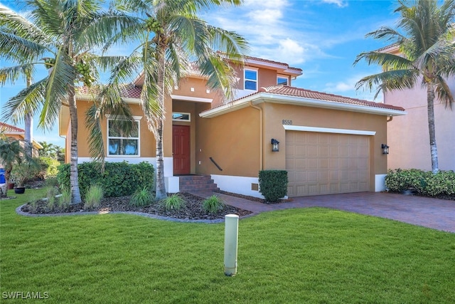 mediterranean / spanish-style home with a garage and a front yard