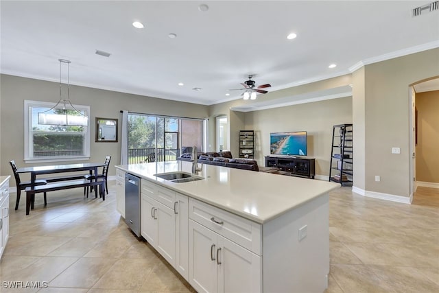 kitchen featuring an island with sink, pendant lighting, stainless steel dishwasher, white cabinets, and sink