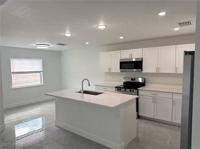 kitchen featuring white cabinets, appliances with stainless steel finishes, an island with sink, and sink