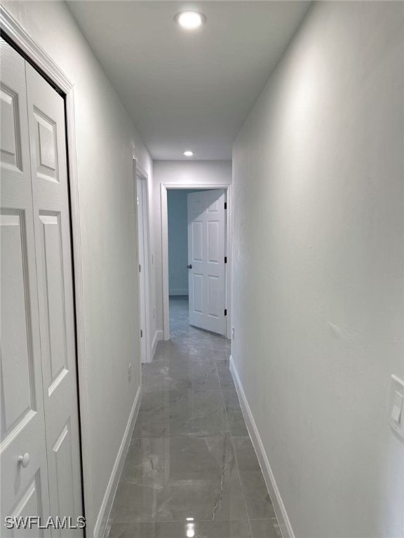 3708 15th St SW, Lehigh Acres, FL 33976 - corridor featuring baseboards, marble finish floors, and recessed lighting