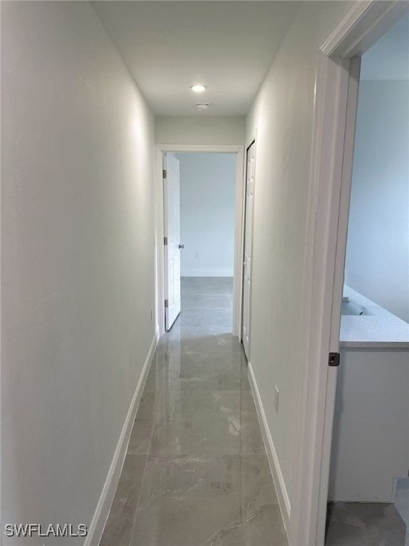 3708 15th St SW, Lehigh Acres, FL 33976 - corridor with baseboards and light marble finish floors