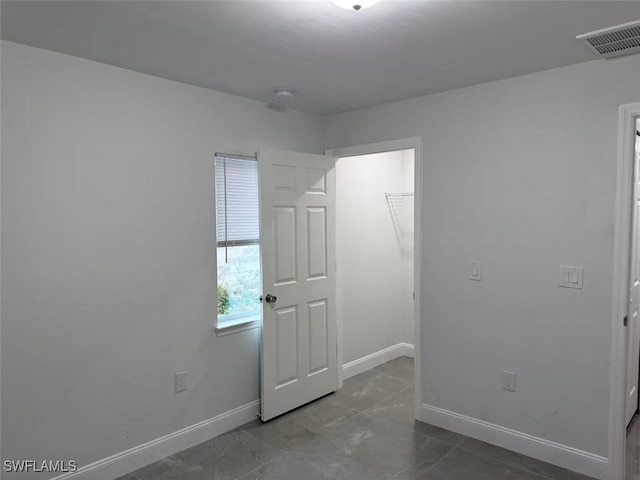 unfurnished bedroom featuring tile patterned flooring