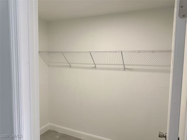 walk in closet with tile patterned floors