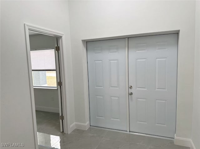 3708 15th St SW, Lehigh Acres, FL 33976 - entryway featuring baseboards and marble look tile flooring