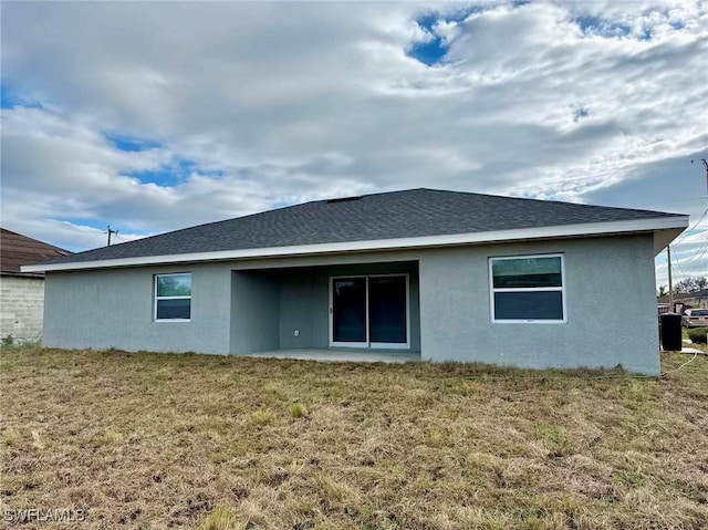 back of property featuring a yard and a patio area