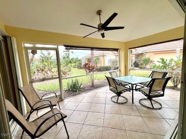 sunroom featuring ceiling fan