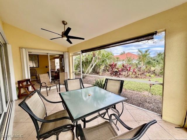 sunroom with lofted ceiling and ceiling fan