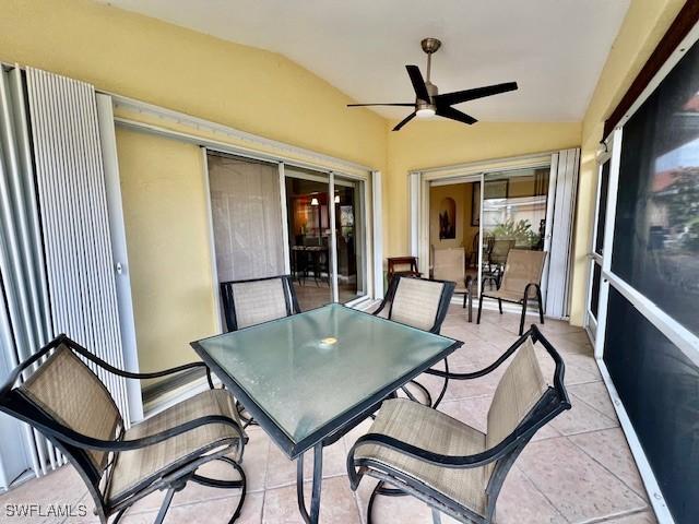 sunroom featuring ceiling fan and vaulted ceiling