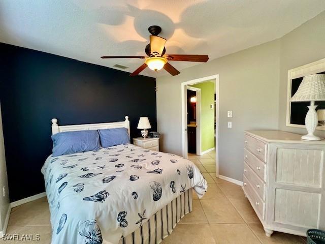 tiled bedroom with ceiling fan