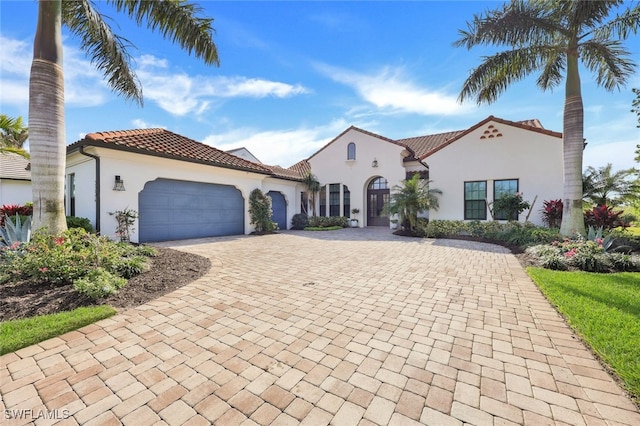 mediterranean / spanish home featuring a garage