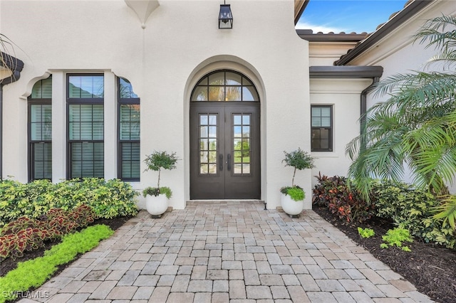 view of exterior entry featuring french doors