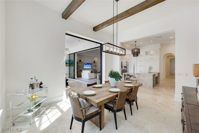 dining space with beam ceiling