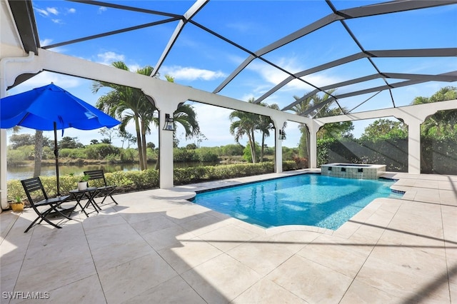 view of pool featuring a patio, a water view, glass enclosure, and an in ground hot tub