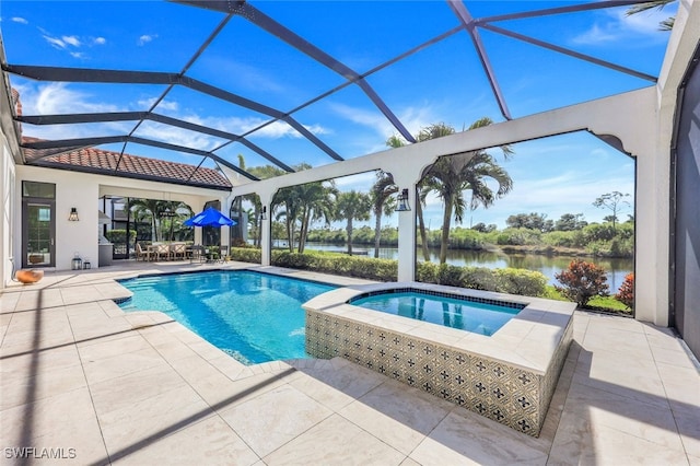 view of pool featuring an in ground hot tub, a patio area, glass enclosure, and a water view