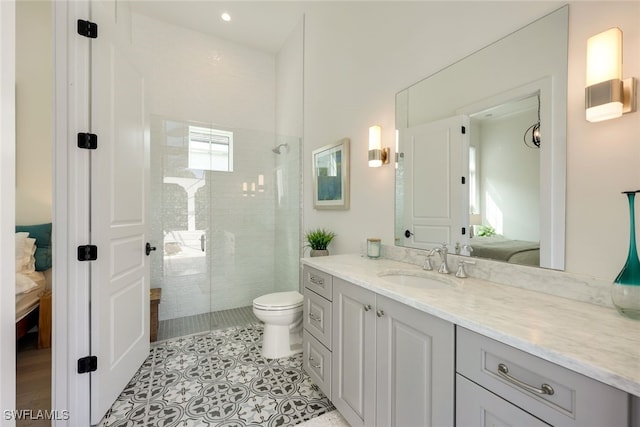 bathroom with a tile shower, toilet, tile patterned flooring, and vanity