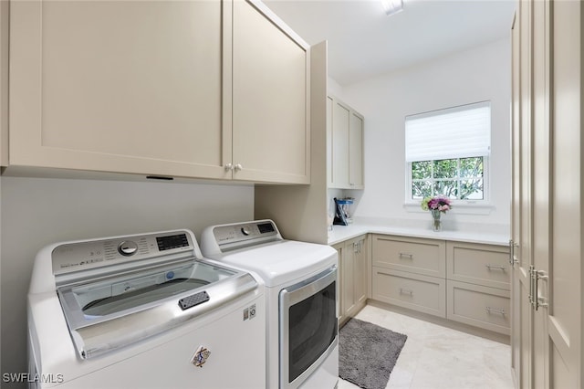 washroom featuring cabinets and washer and dryer