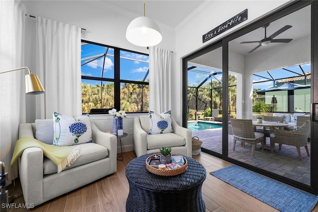 sunroom / solarium featuring a healthy amount of sunlight, a swimming pool, and ceiling fan