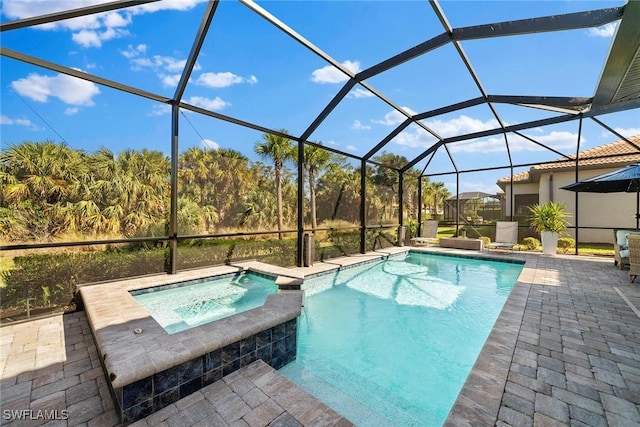 view of pool featuring a lanai, an in ground hot tub, and a patio area