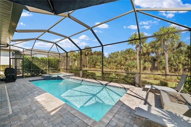 view of swimming pool featuring a lanai, an in ground hot tub, and a patio area