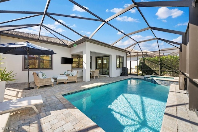 view of pool featuring an outdoor hangout area, a patio area, glass enclosure, and an in ground hot tub