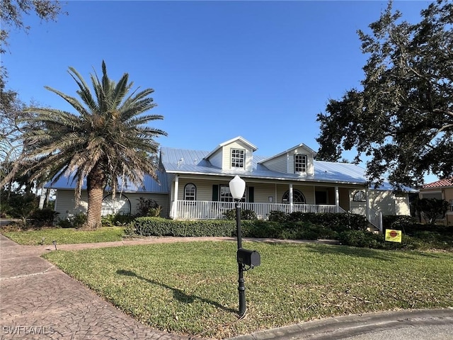 view of front of home with a front yard and covered porch