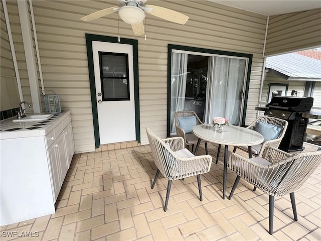 view of patio / terrace featuring area for grilling, sink, and ceiling fan