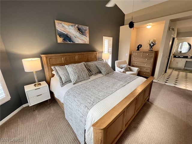 bedroom featuring light carpet and lofted ceiling