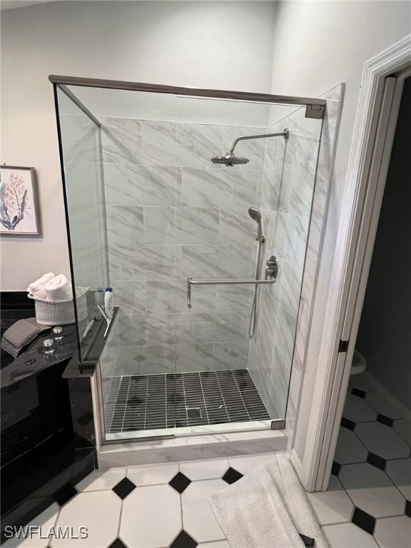 bathroom with tile patterned floors and an enclosed shower