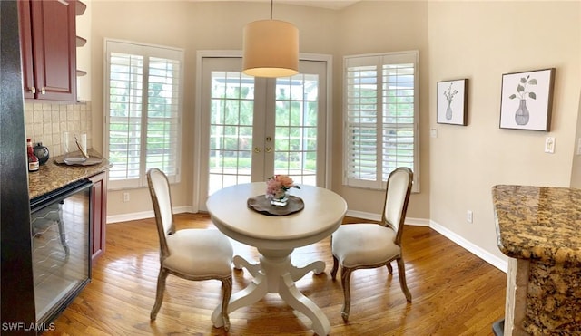 dining room with french doors and wood-type flooring