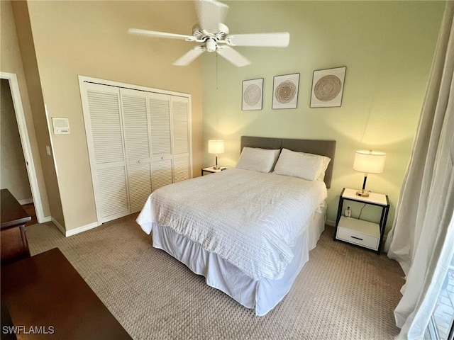 bedroom featuring ceiling fan, light carpet, and a closet