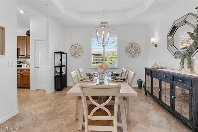 dining space featuring a raised ceiling, light tile patterned flooring, and a chandelier