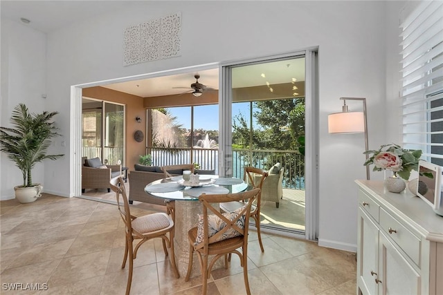 dining space featuring ceiling fan and light tile patterned floors