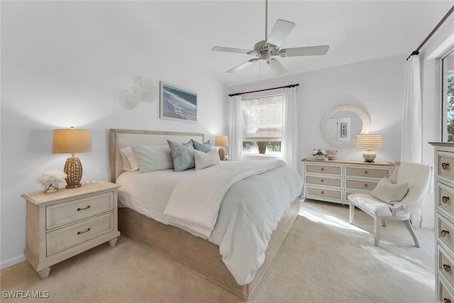 carpeted bedroom featuring ceiling fan and vaulted ceiling