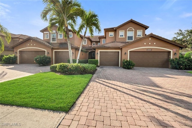 view of front facade with a garage and a front lawn