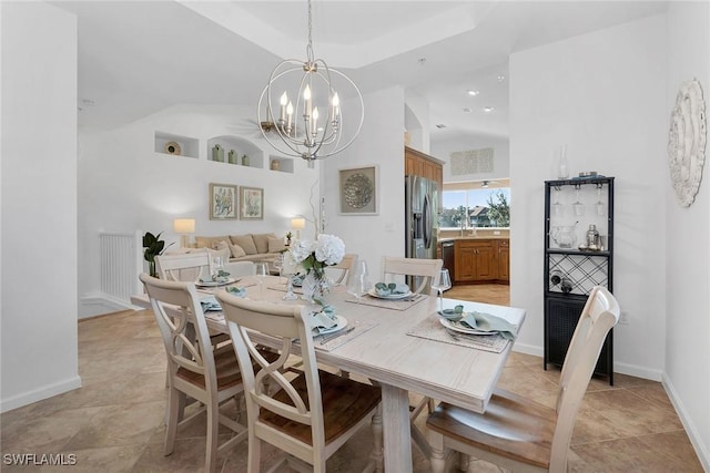 dining area with a notable chandelier, light tile patterned flooring, and a high ceiling