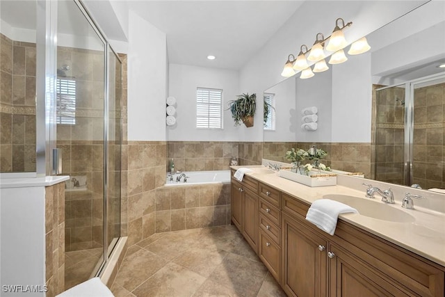 bathroom featuring tile patterned flooring, independent shower and bath, and vanity