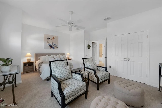 carpeted bedroom featuring ceiling fan and a closet