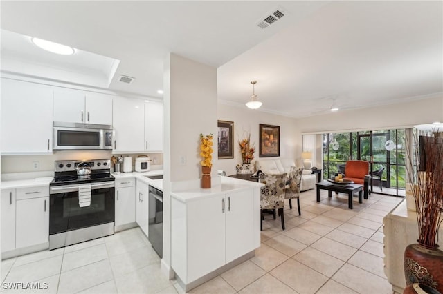 kitchen with light tile patterned floors, stainless steel appliances, pendant lighting, and white cabinetry