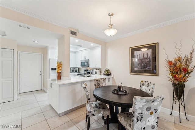 tiled dining room with crown molding