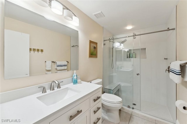 bathroom with toilet, tile patterned floors, walk in shower, and vanity