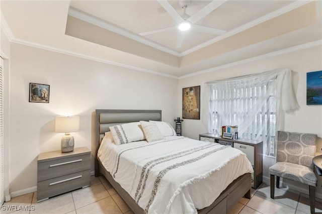 tiled bedroom with ceiling fan, ornamental molding, and a raised ceiling