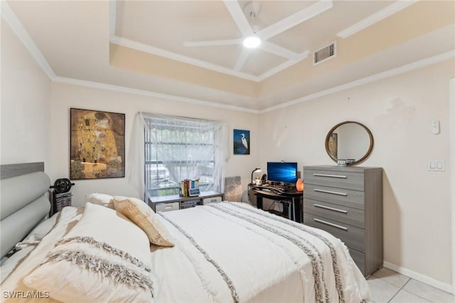 tiled bedroom with ceiling fan, a raised ceiling, and ornamental molding