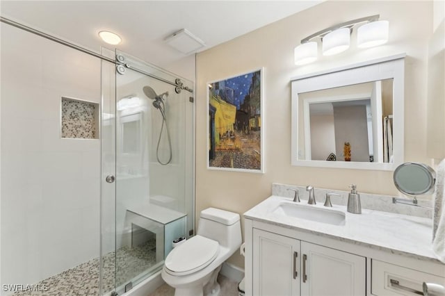 bathroom with toilet, an enclosed shower, and vanity