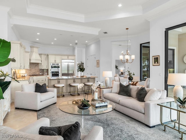 6564 Costa Cir, Naples, FL 34113 - living area featuring a tray ceiling, a chandelier, recessed lighting, and ornamental molding