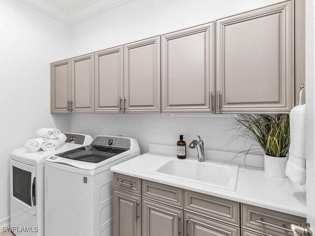6564 Costa Cir, Naples, FL 34113 - laundry room featuring washing machine and dryer, cabinet space, and ornamental molding