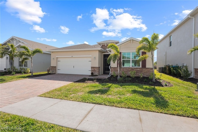 view of front of house with a garage and a front lawn