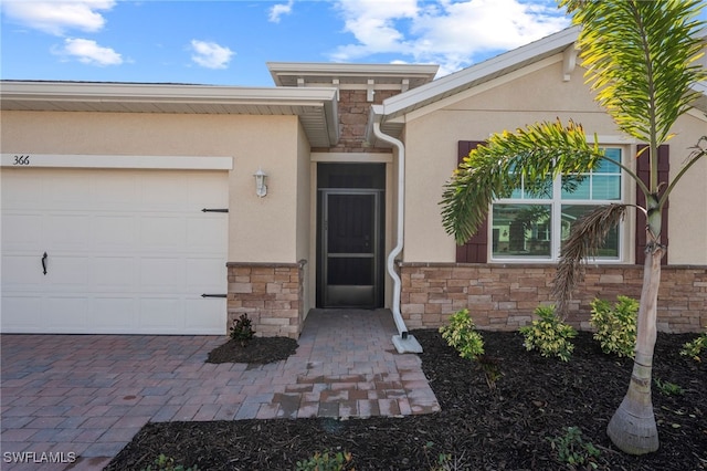 doorway to property with a garage