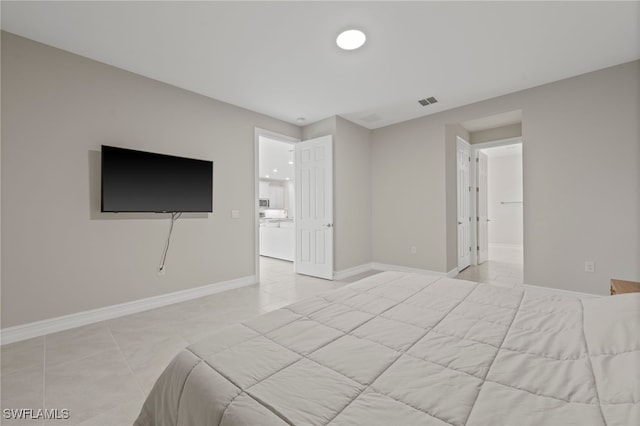 bedroom with light tile patterned floors